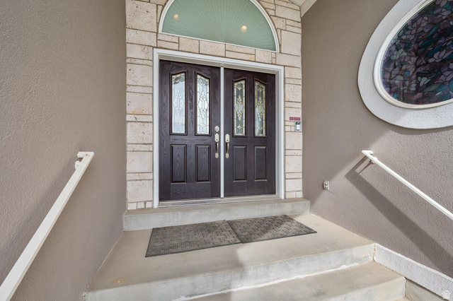 708 Eagle Rdg Drive Bountiful, UT 84010 - Photo 2 of 69 Entry view 1, double doors with decorative glass panels and dark wood finish, set within a stone surround