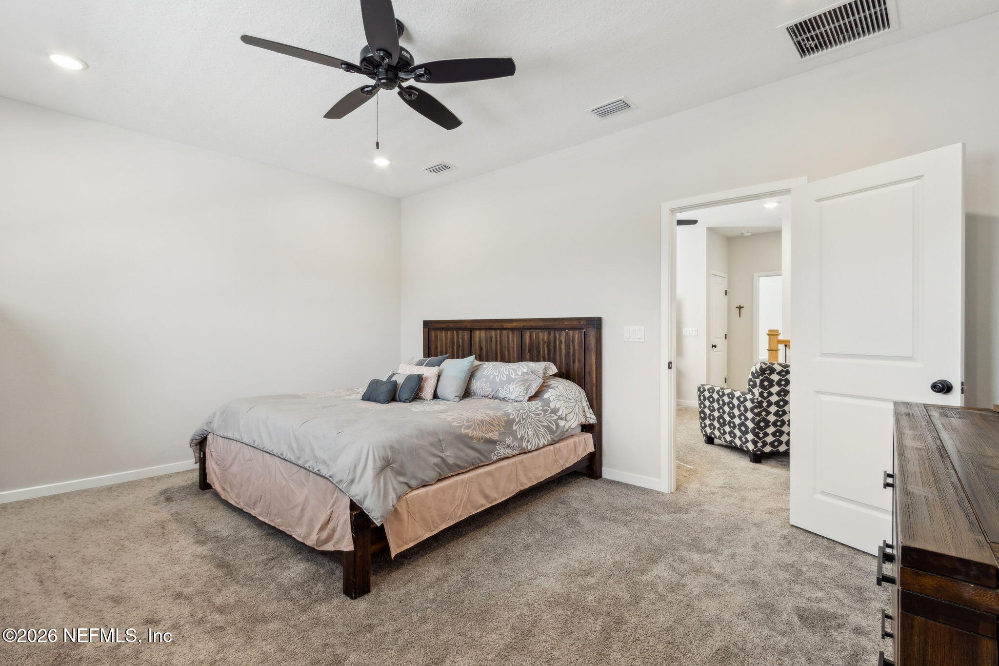 96277 Broadmoore Road Fernandina Beach, FL 32034 - Photo 20 of 31 a spacious bedroom with a bed and a table in it