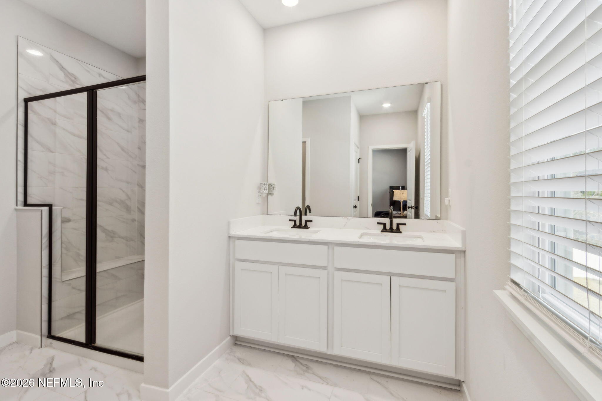 96277 Broadmoore Road Fernandina Beach, FL 32034 - Photo 21 of 31 a bathroom with a double vanity sink and mirror
