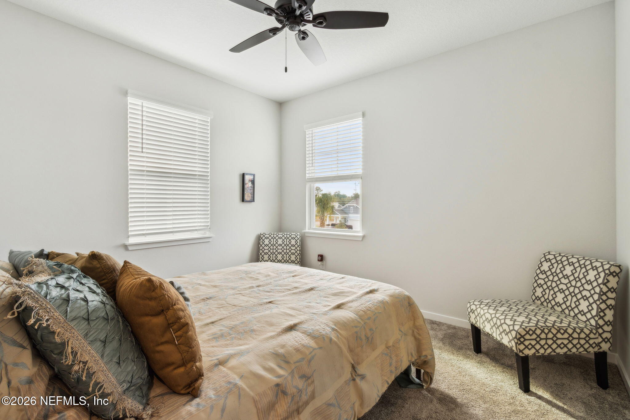 96277 Broadmoore Road Fernandina Beach, FL 32034 - Photo 23 of 31 a bedroom with a bed and a chair