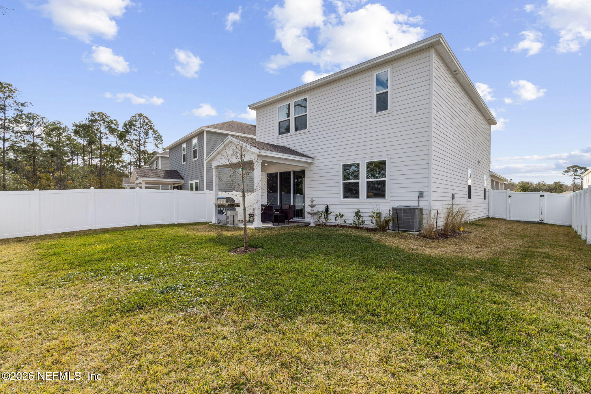 96277 Broadmoore Road Fernandina Beach, FL 32034 - Photo 30 of 31 a view of a house with a yard patio and swimming pool