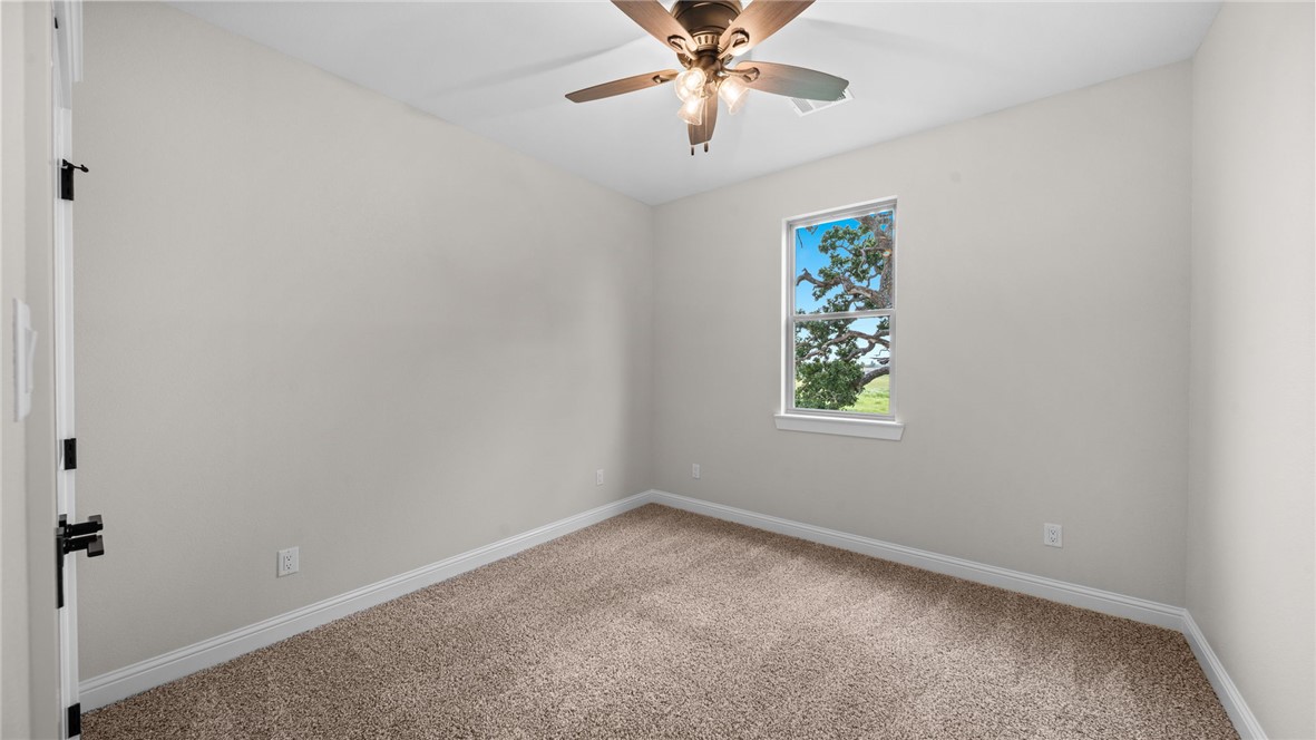 162 Buffalo Rdg Road Giddings, TX 78942 - Photo 20 of 31 an empty room with windows and fan