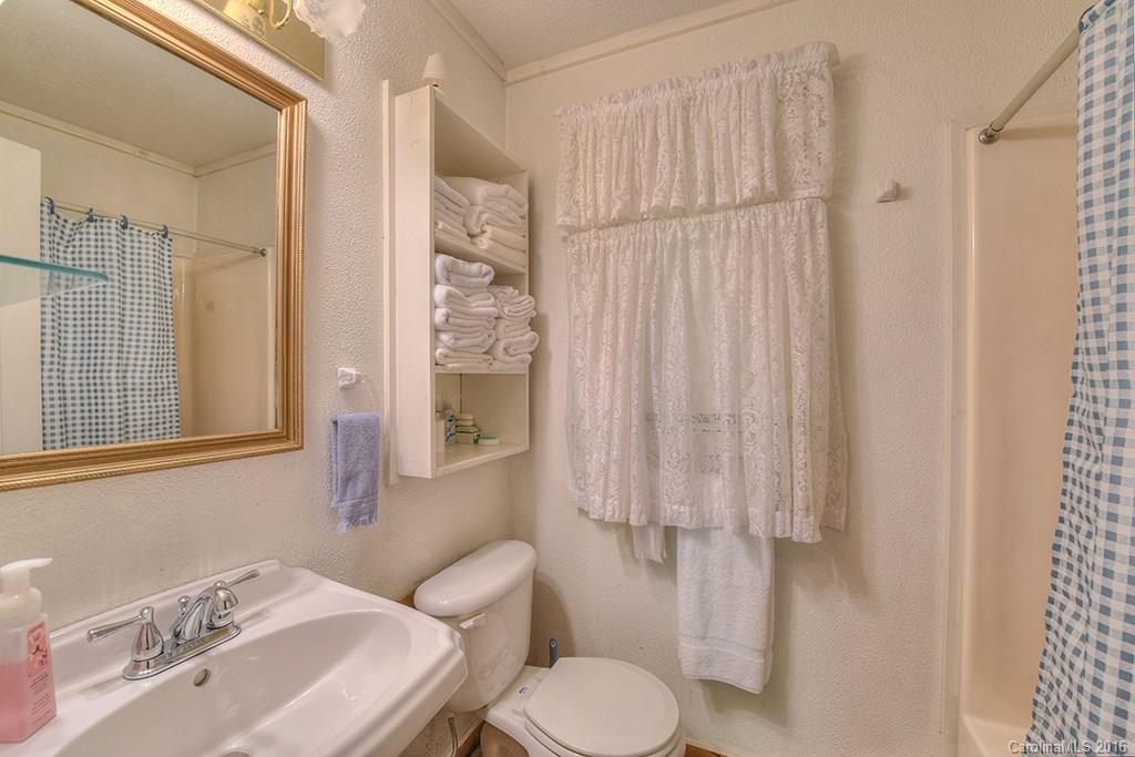 85 Miner Road Waynesville, NC 28785 - Photo 13 of 24 a bathroom with a sink toilet and shower