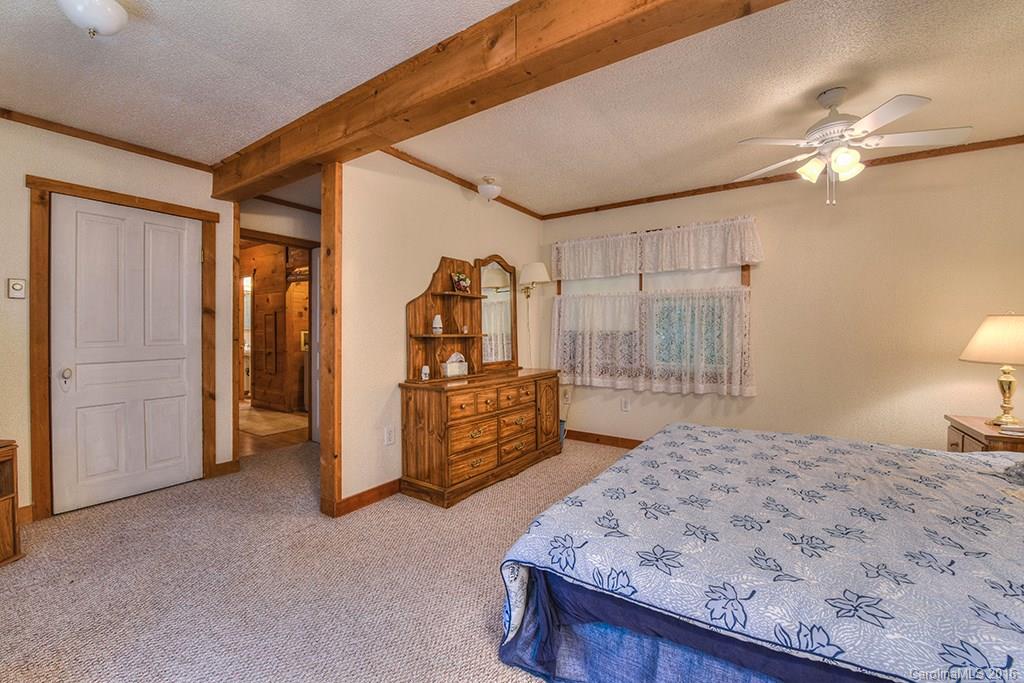85 Miner Road Waynesville, NC 28785 - Photo 18 of 24 a spacious bedroom with a bed and a bathroom