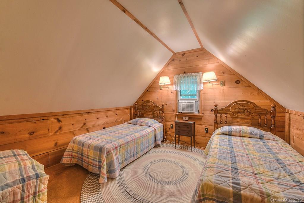 85 Miner Road Waynesville, NC 28785 - Photo 22 of 24 a spacious bedroom with two beds and painted walls