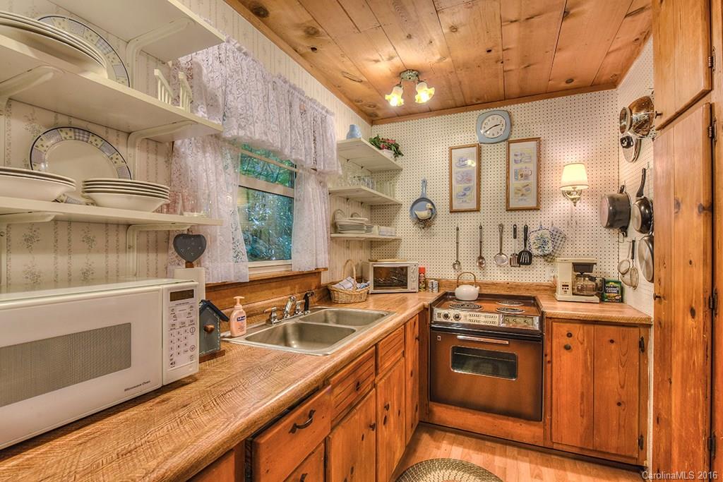 85 Miner Road Waynesville, NC 28785 - Photo 9 of 24 a kitchen that has a sink a stove and a wooden floors