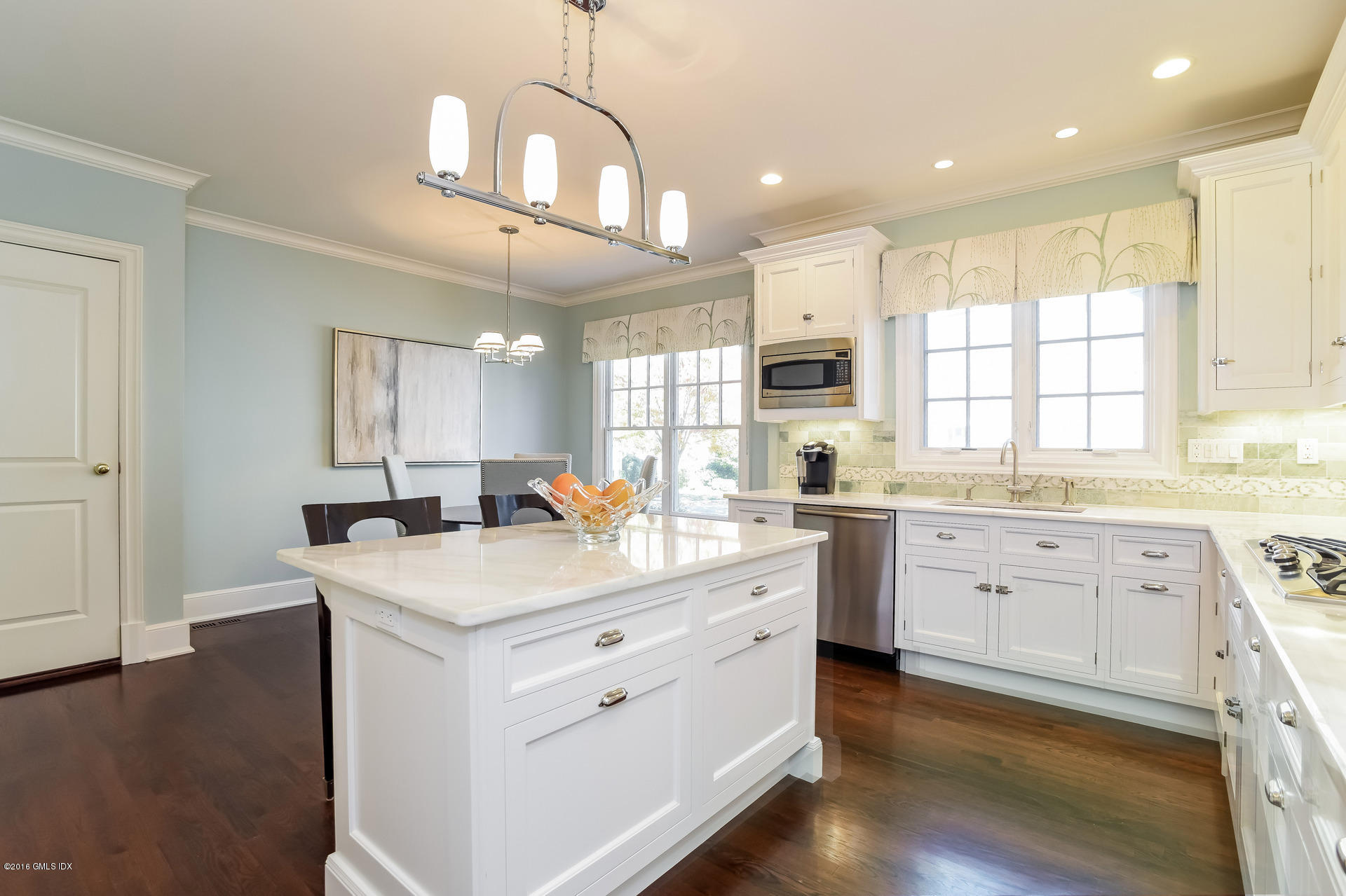 631 Long Ridge Road, Unit 57 Stamford, CT 06902 - Photo 8 of 29 a kitchen with a white center island and cabinets