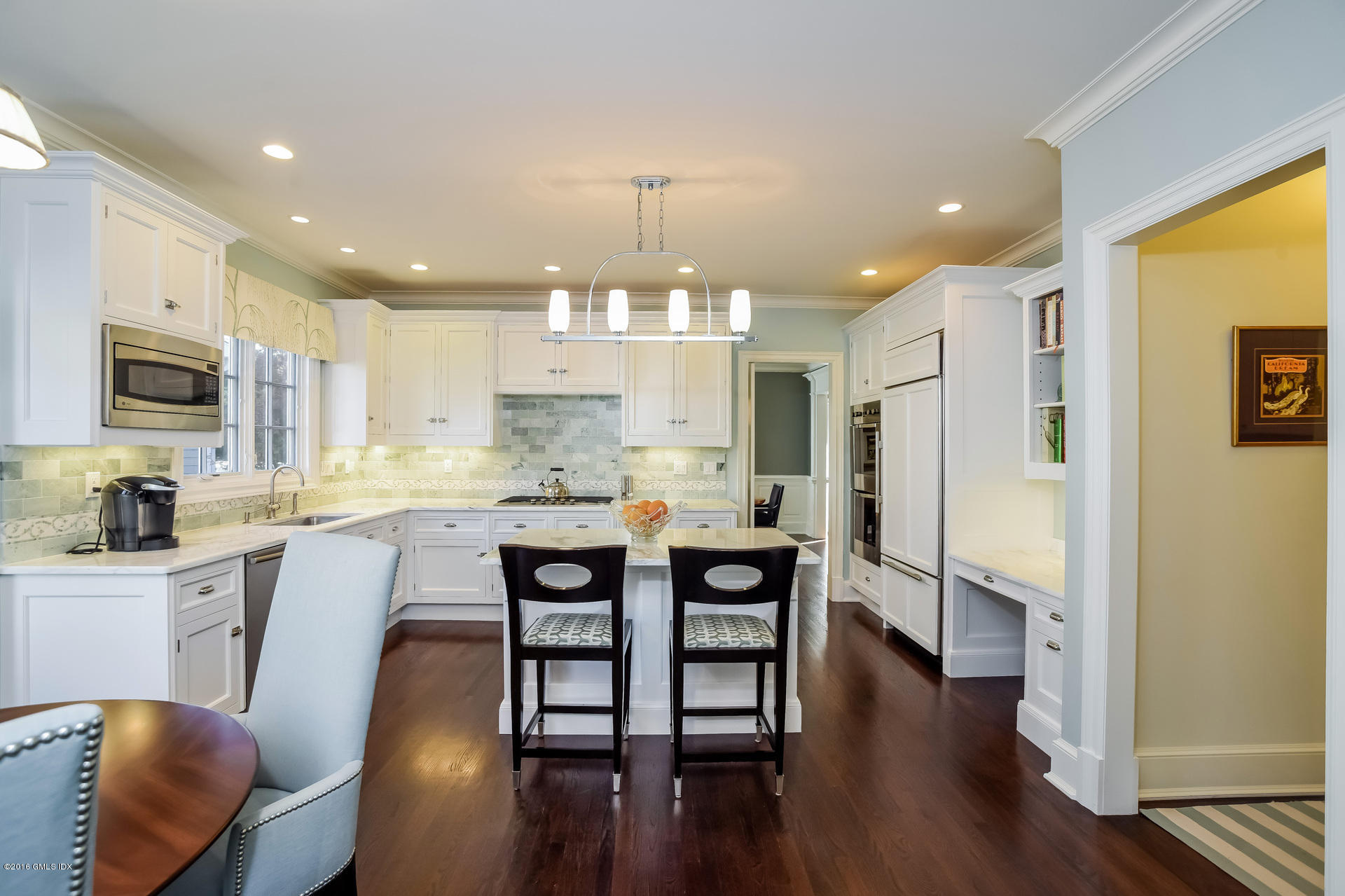 631 Long Ridge Road, Unit 57 Stamford, CT 06902 - Photo 9 of 29 a kitchen with stainless steel appliances granite countertop a refrigerator a stove a sink dishwasher and a dining table with wooden floor