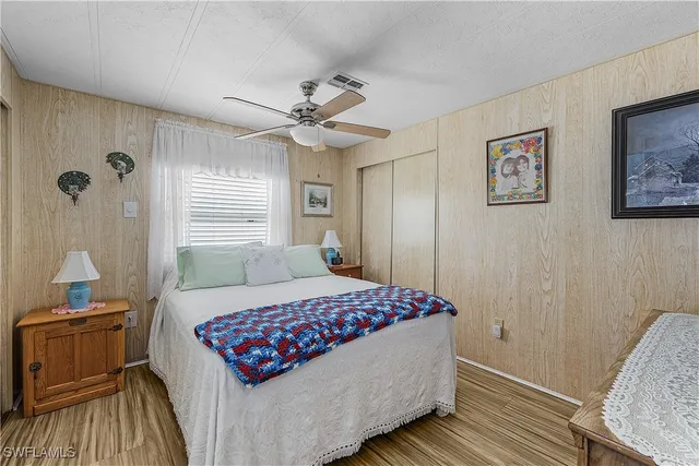 a bedroom with a bed dresser and a window