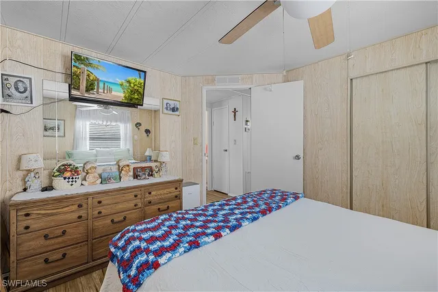 a view of a hallway with wooden floor and closet