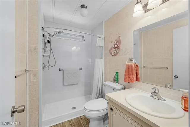 a living room with furniture a chandelier and a fireplace
