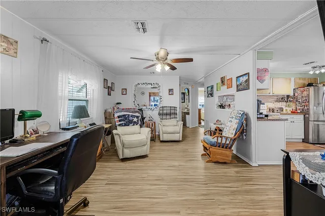 a living room with furniture fireplace and a window