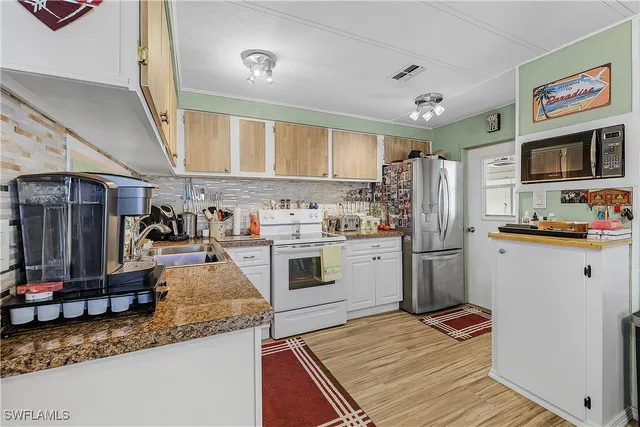 a living room with furniture kitchen and a kitchen view