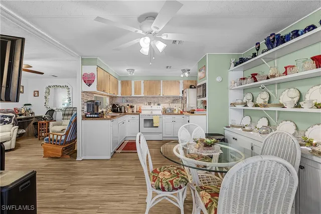 a living room with furniture kitchen and a chandelier
