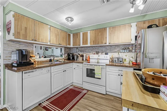 a living room with furniture a flat screen tv and wooden floor