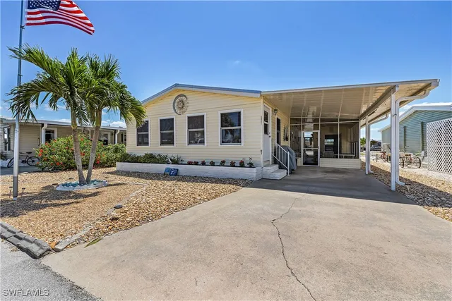 a living room with furniture a flat screen tv and windows