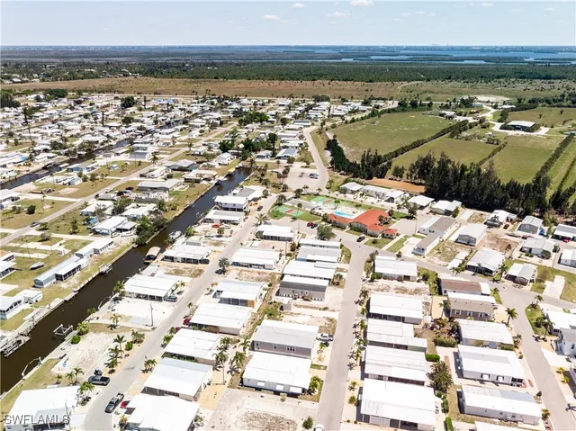 an aerial view of residential houses with yard