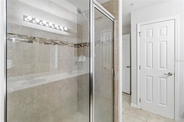 an empty room with window and ceiling fan