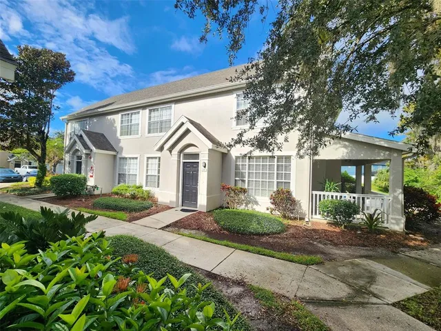a view of a white house with a yard