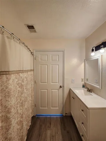 a bathroom with a sink a mirror and a shower