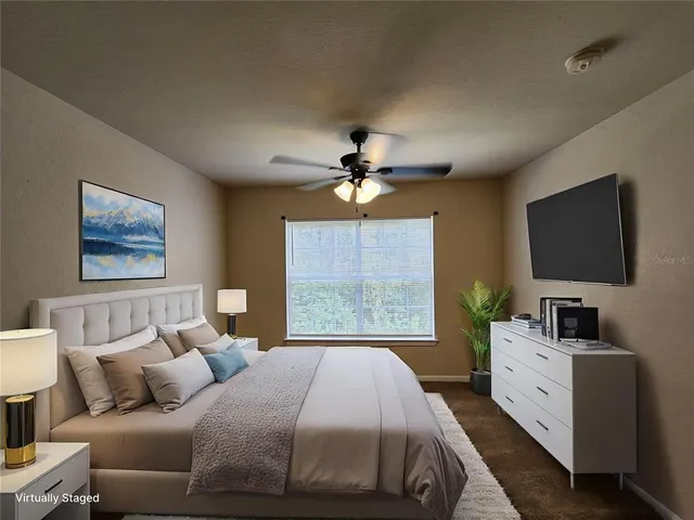 a bedroom with a large bed and a flat screen tv