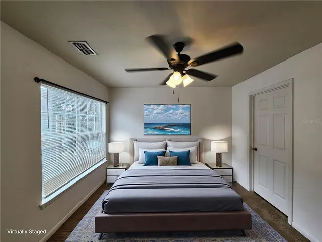 a bedroom with a large bed and a large window