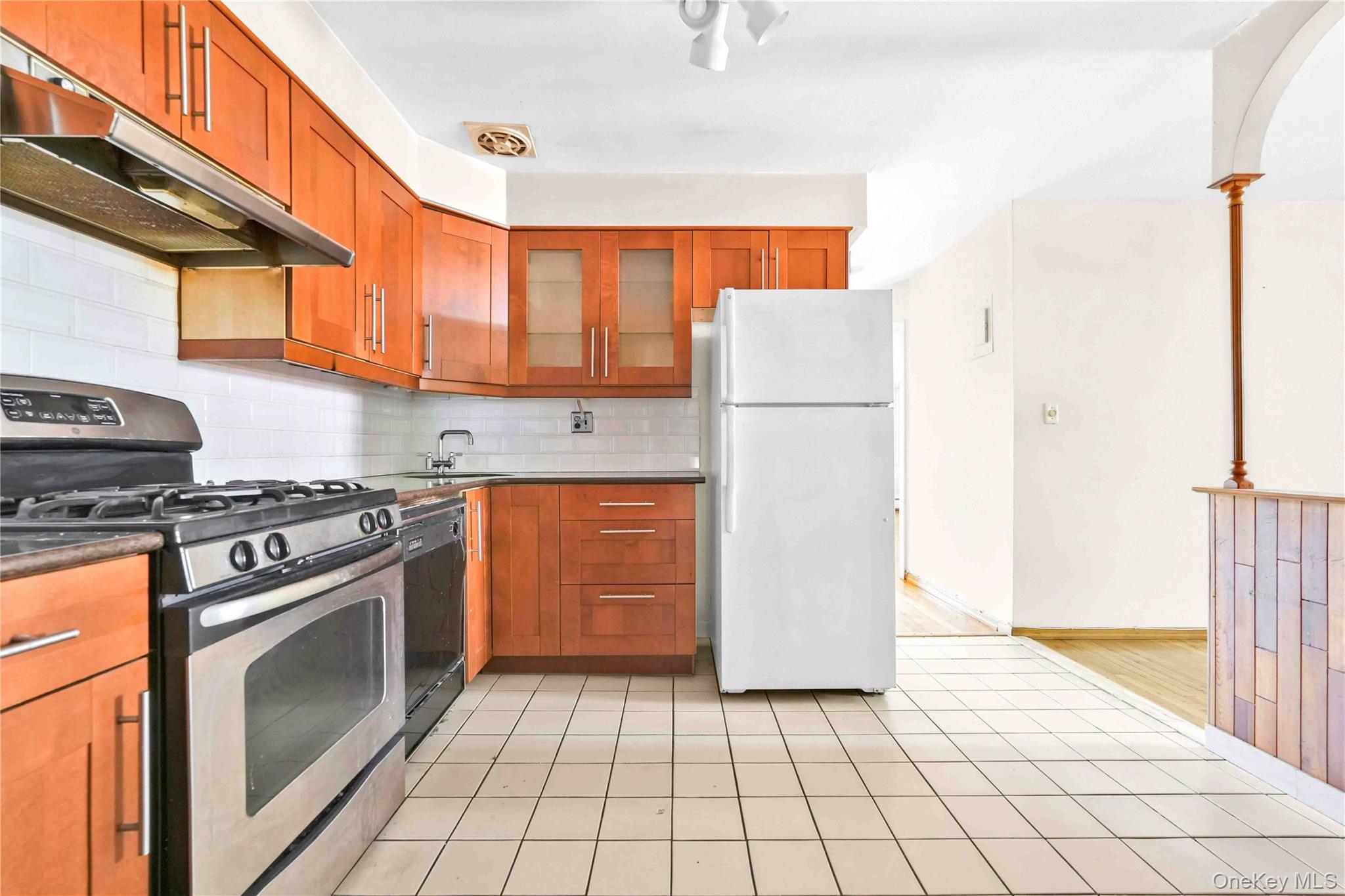 21260 16th Avenue Queens, NY 11360 - Photo 11 of 37 a kitchen with a stove top oven and cabinets