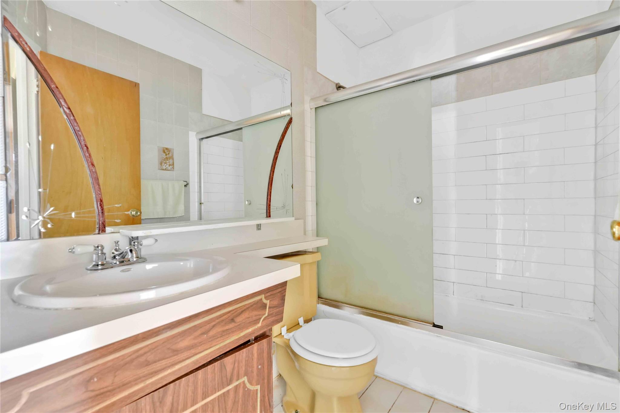 21260 16th Avenue Queens, NY 11360 - Photo 15 of 37 a bathroom with a sink toilet and shower