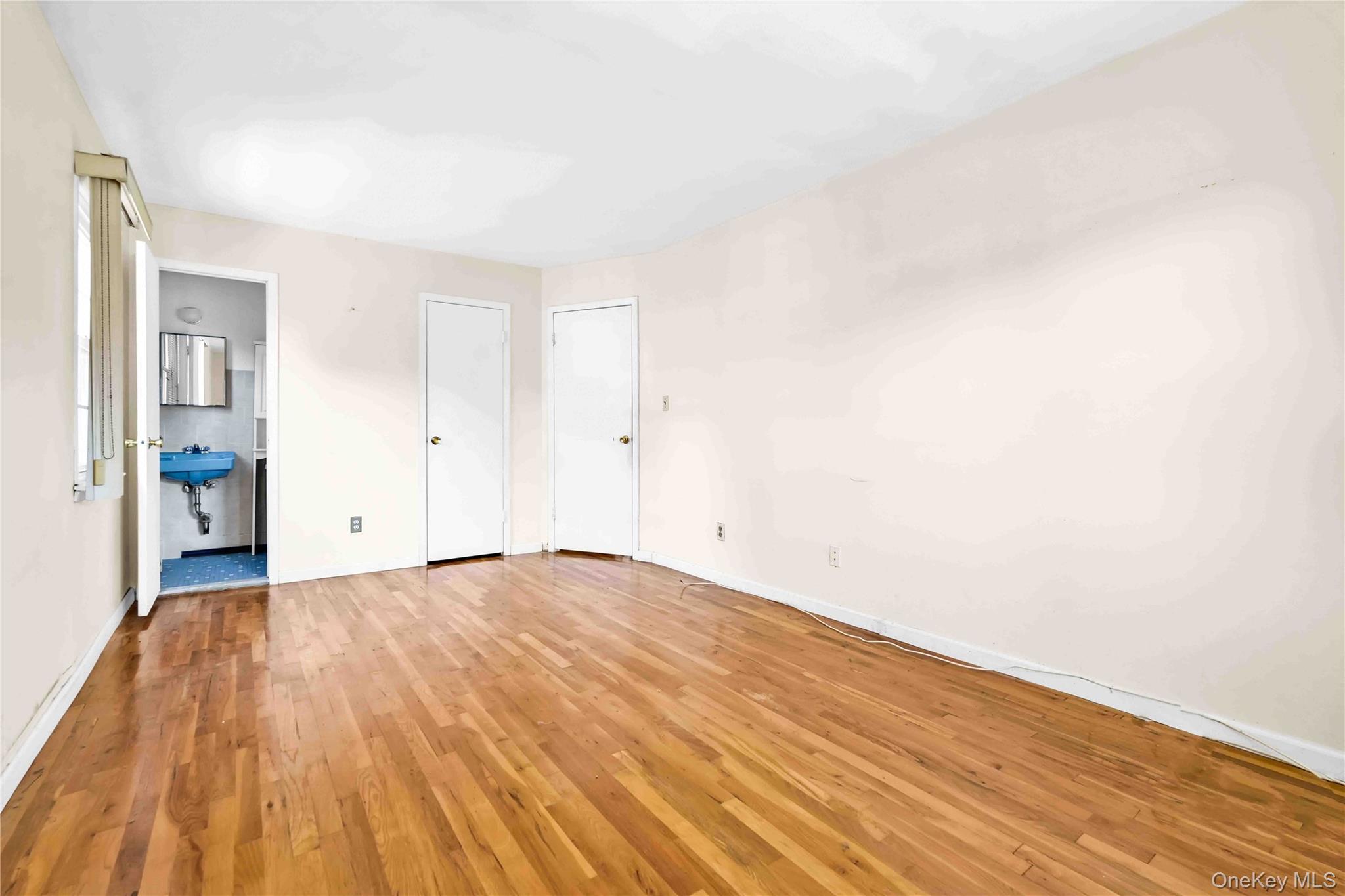 21260 16th Avenue Queens, NY 11360 - Photo 18 of 37 a view of an empty room and wooden floor