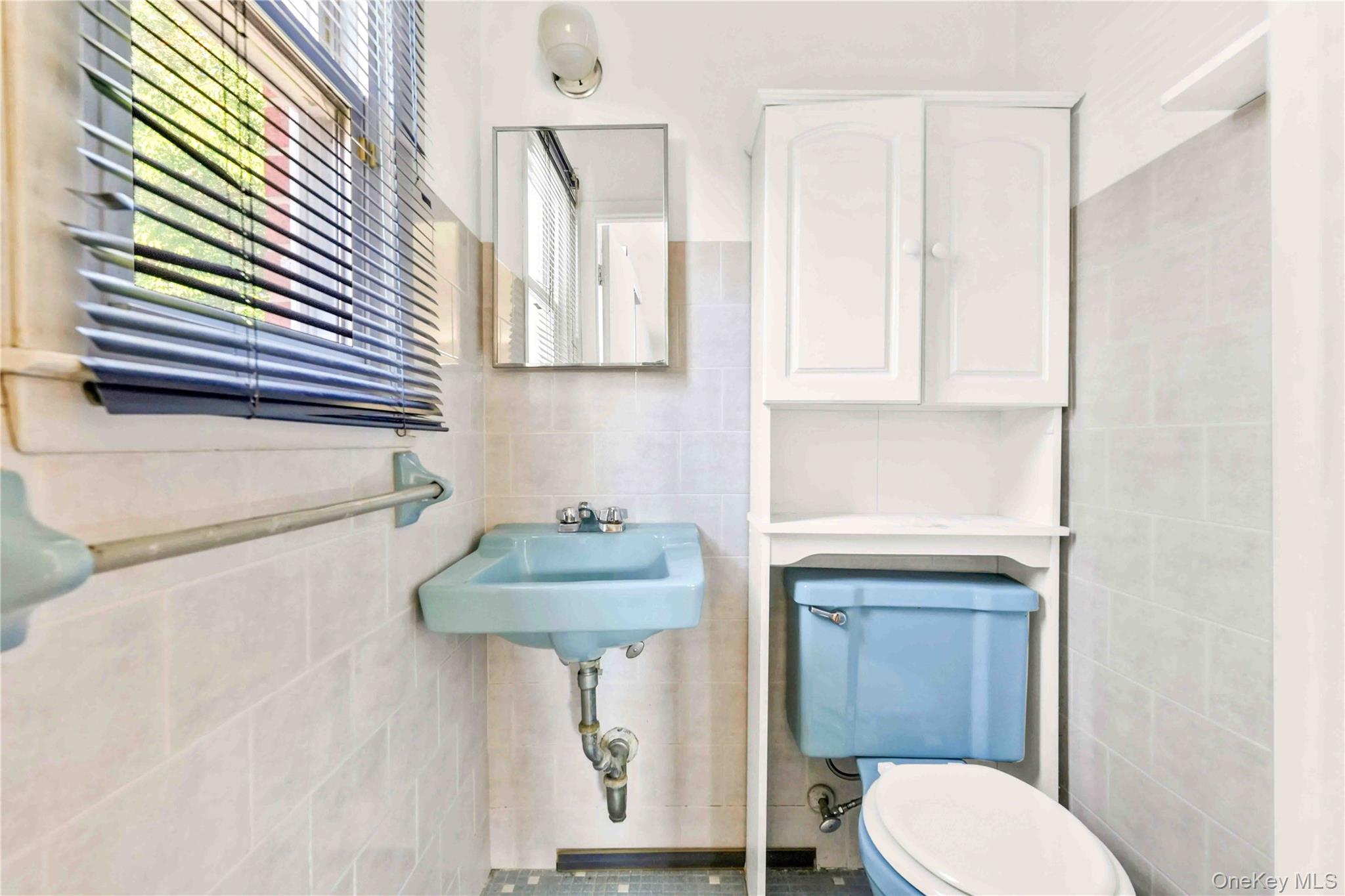 21260 16th Avenue Queens, NY 11360 - Photo 19 of 37 a bathroom with a sink toilet and a mirror