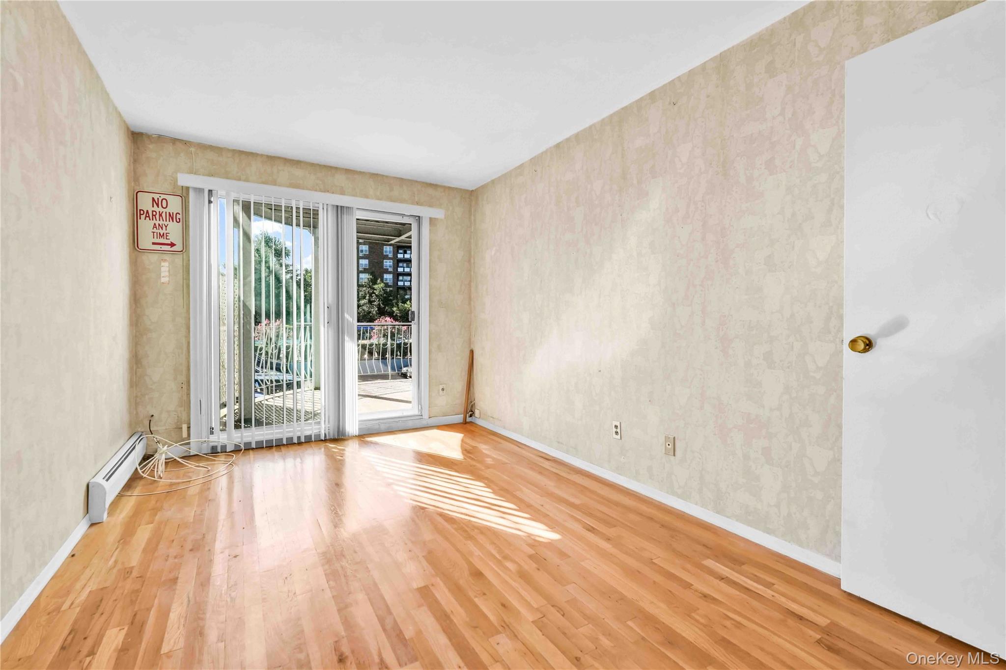 21260 16th Avenue Queens, NY 11360 - Photo 20 of 37 a view of an empty room with wooden floor and a window