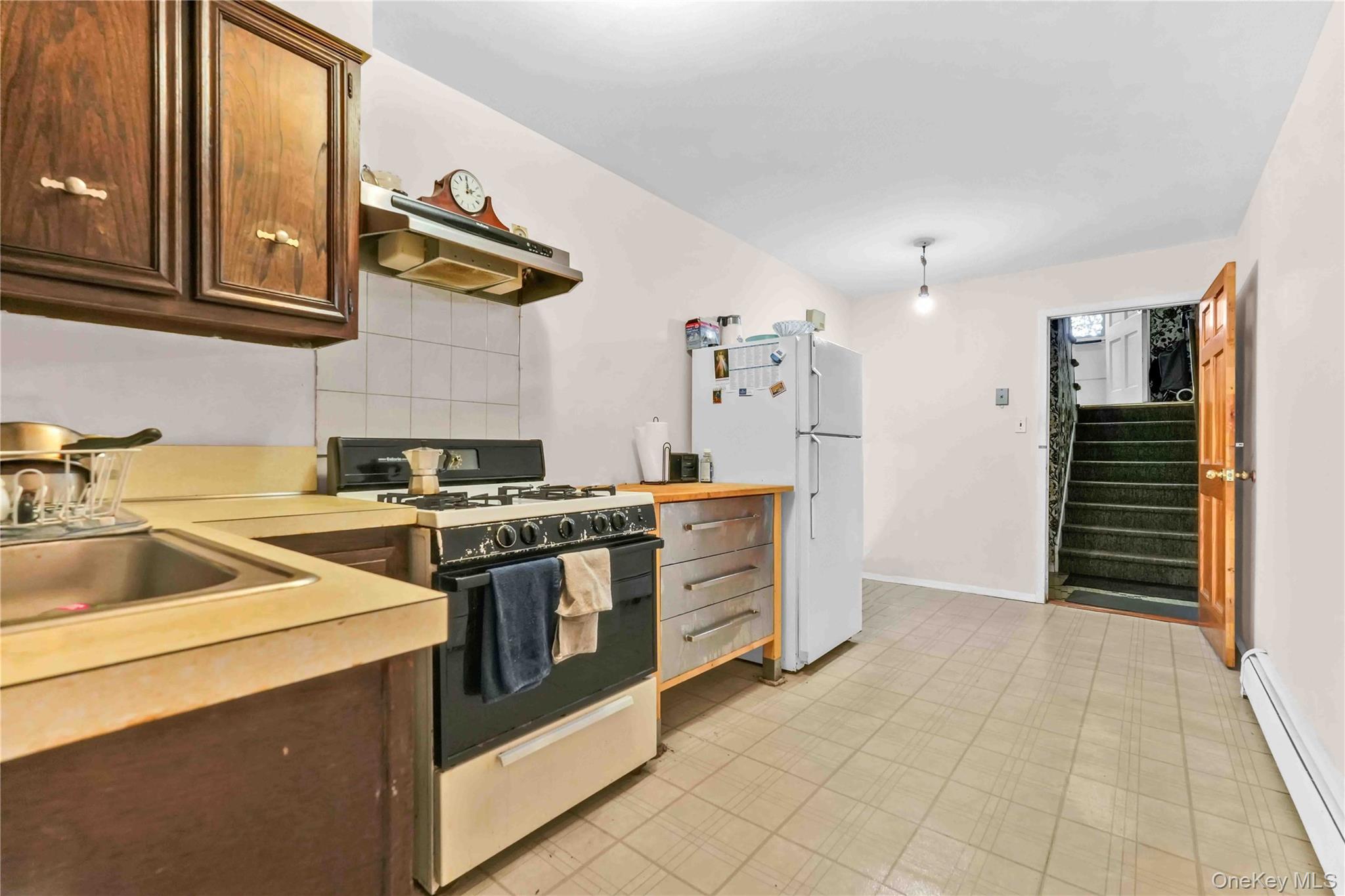 21260 16th Avenue Queens, NY 11360 - Photo 23 of 37 a kitchen that has a sink and a stove