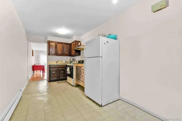 a kitchen with a refrigerator and a sink