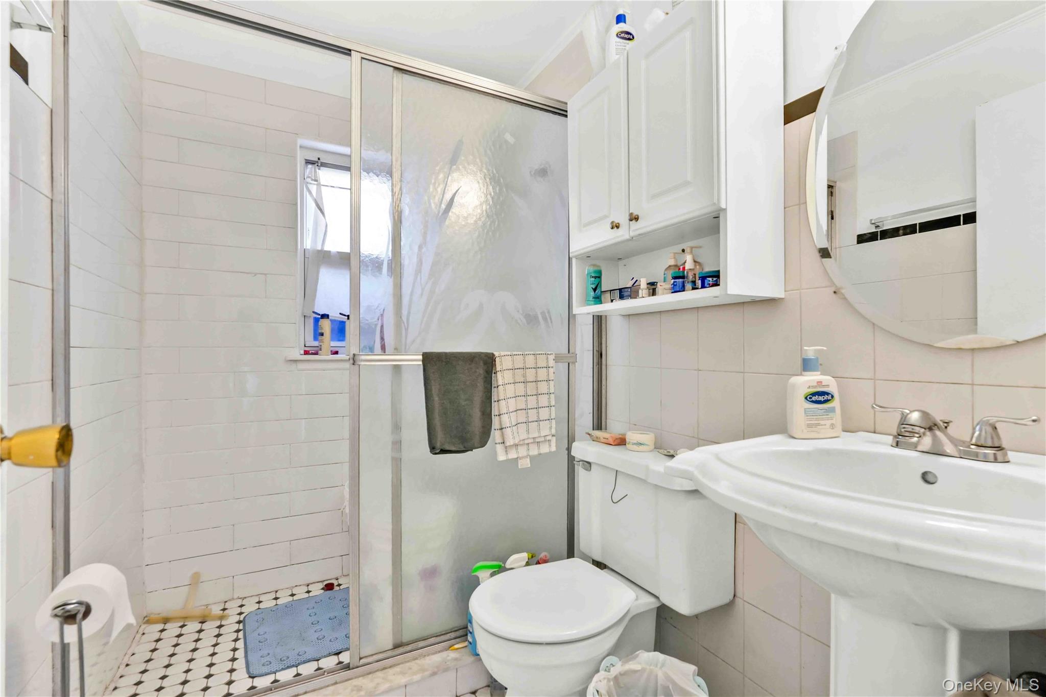 21260 16th Avenue Queens, NY 11360 - Photo 28 of 37 a bathroom with a sink toilet and shower