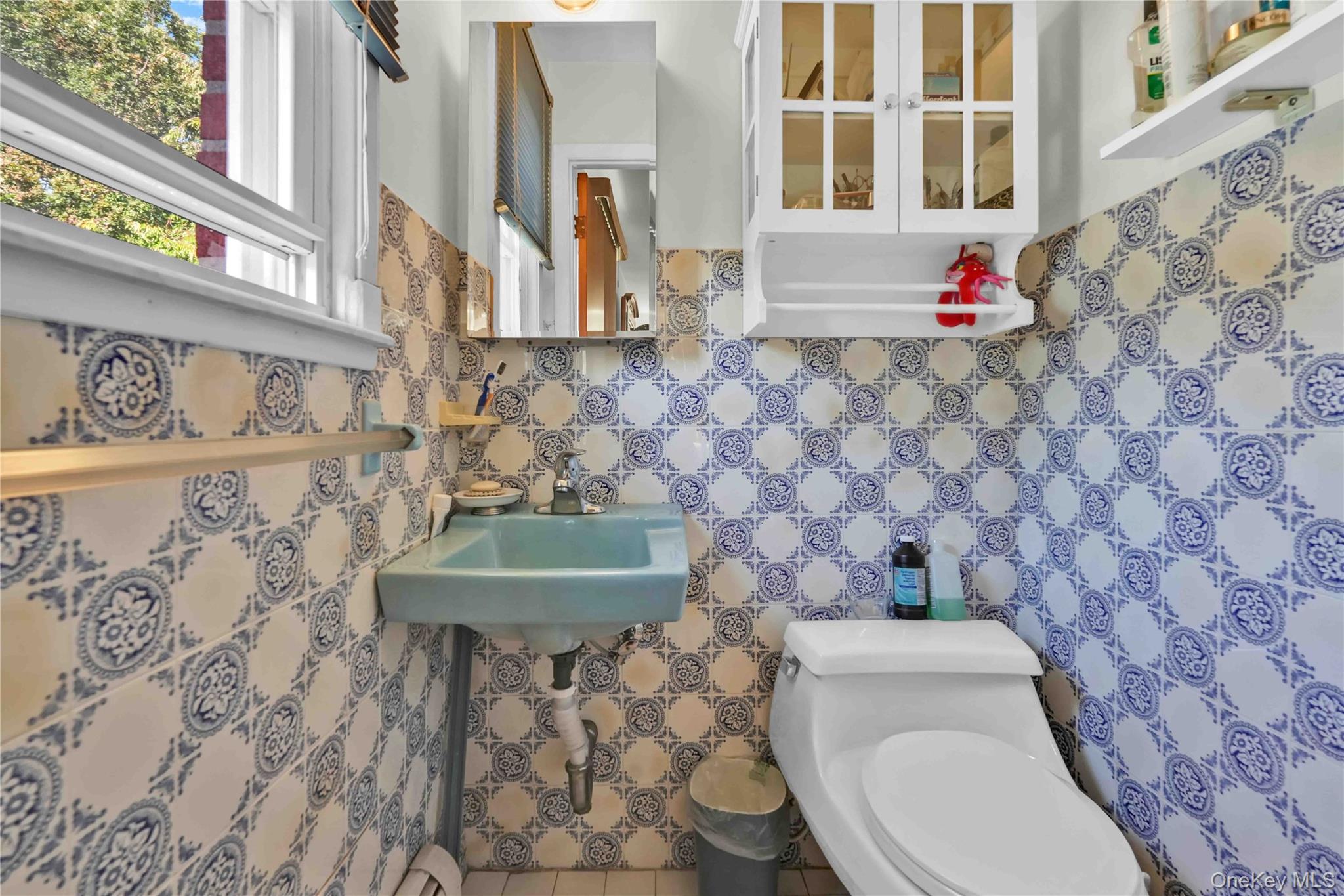 21260 16th Avenue Queens, NY 11360 - Photo 7 of 37 a bathroom with a toilet and a sink