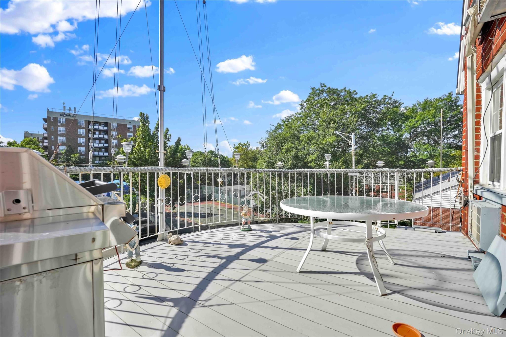 21260 16th Avenue Queens, NY 11360 - Photo 10 of 37 a view of a balcony with wooden floor and fence