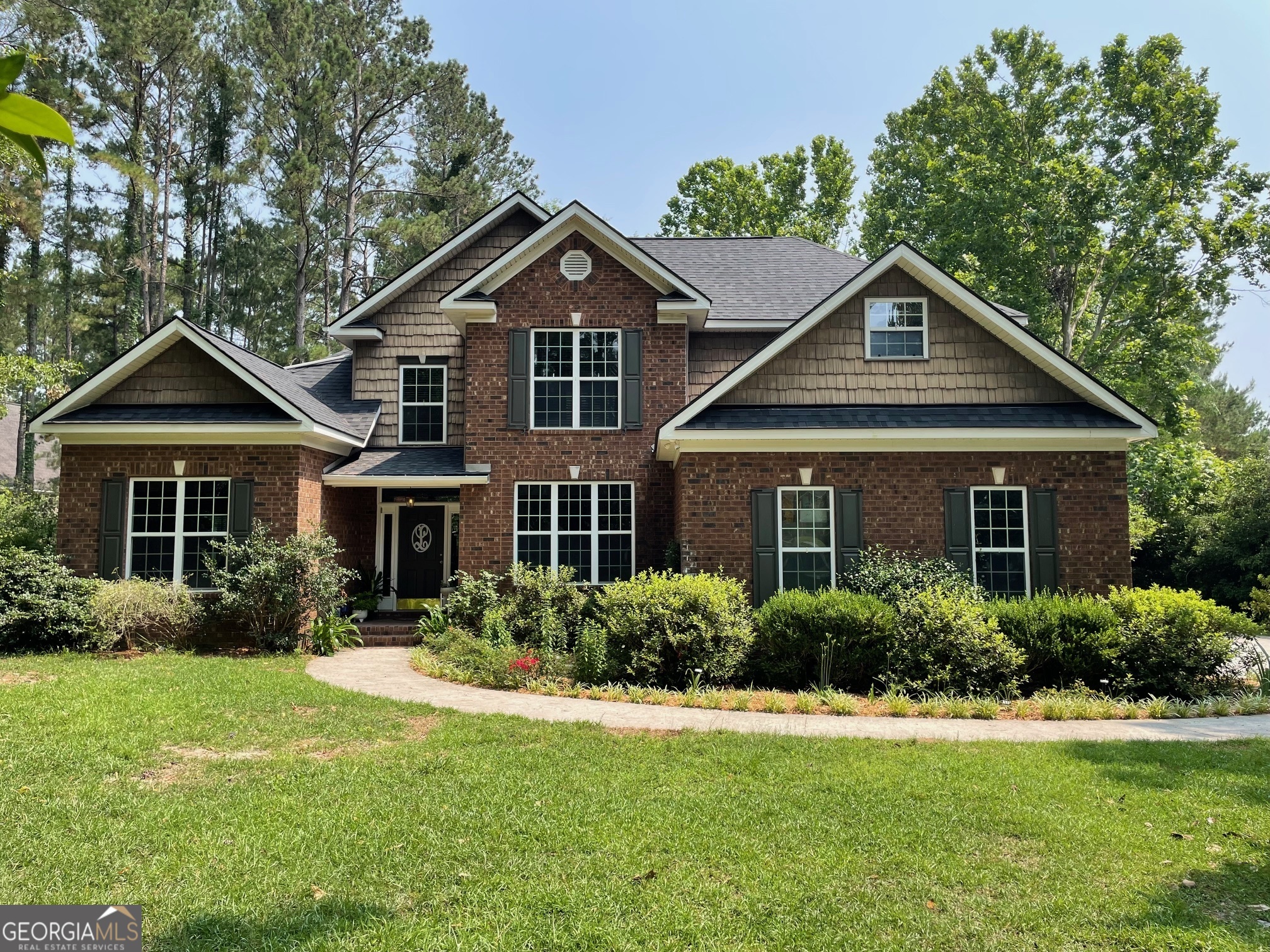 a front view of a house with a yard