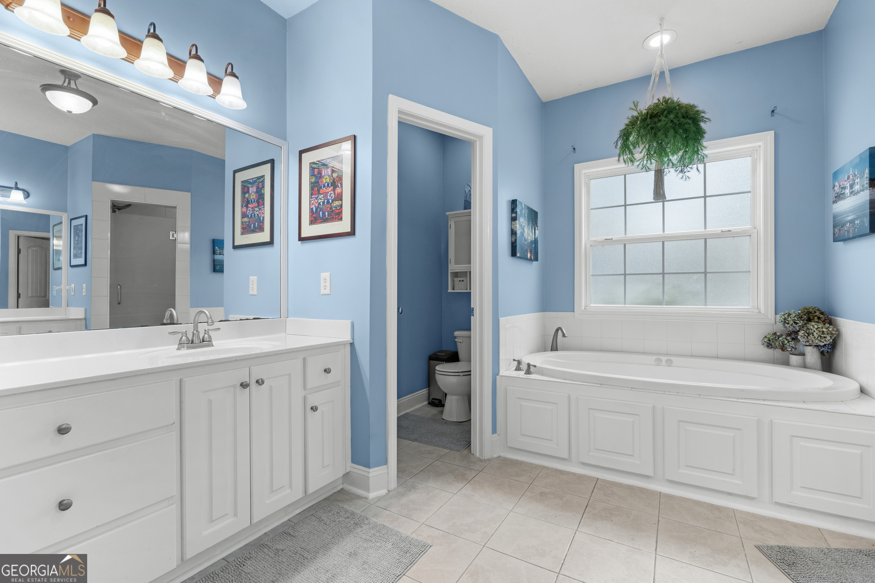 1603 Lennox Road Statesboro, GA 30461 - Photo 23 of 45 a bathroom with a tub sink and mirror