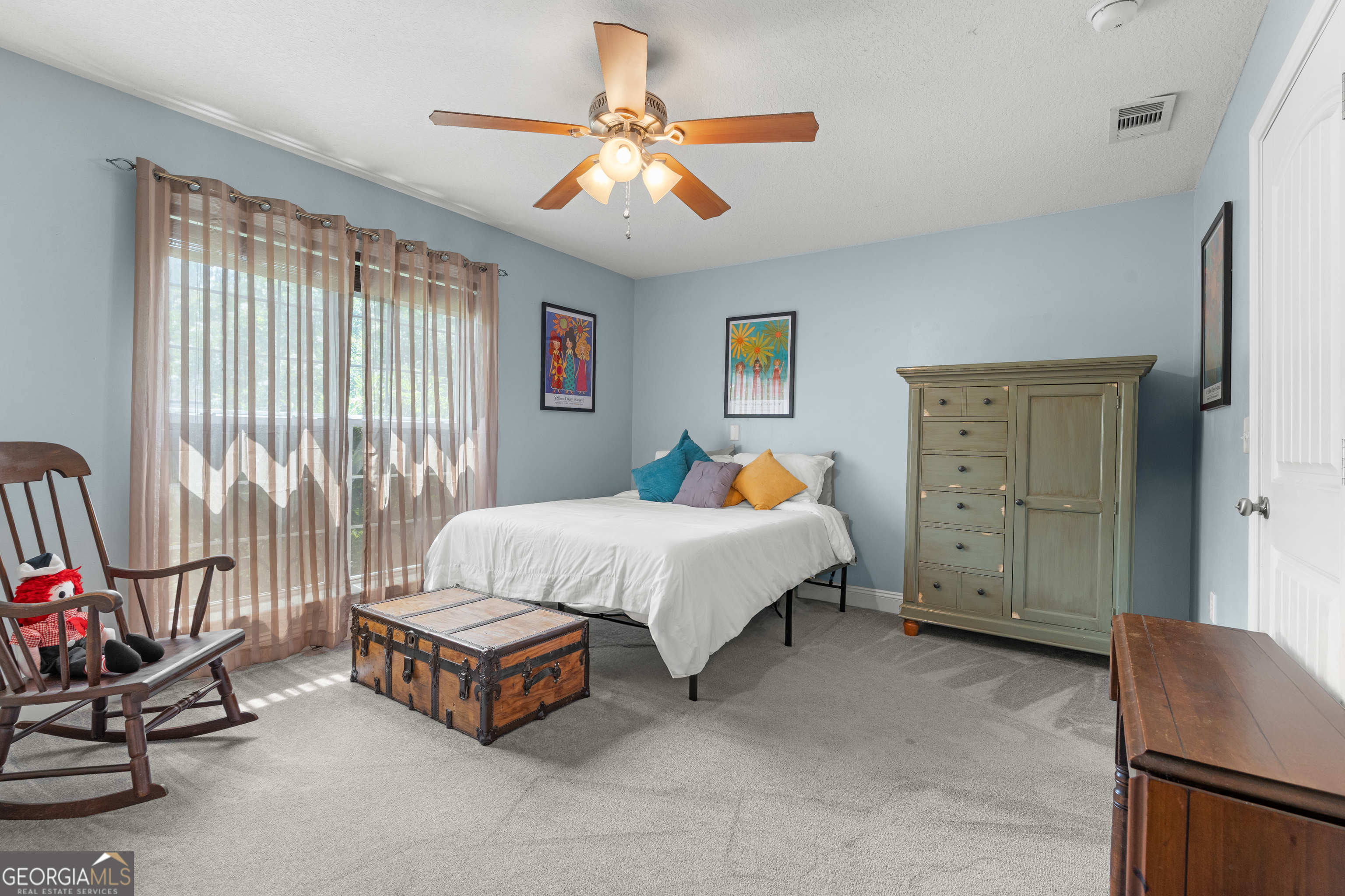 1603 Lennox Road Statesboro, GA 30461 - Photo 29 of 45 a spacious bedroom with a bed and a chandelier
