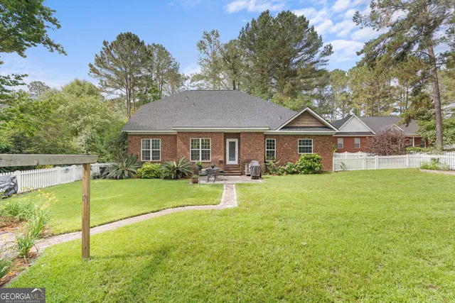 a front view of a house with yard and green space