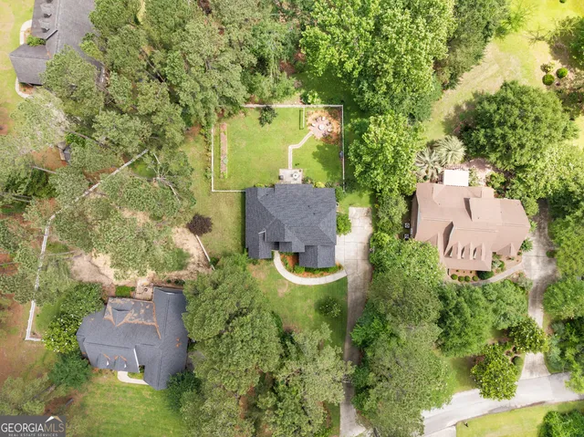 a picture of a room with a refrigerator and a white refrigerator