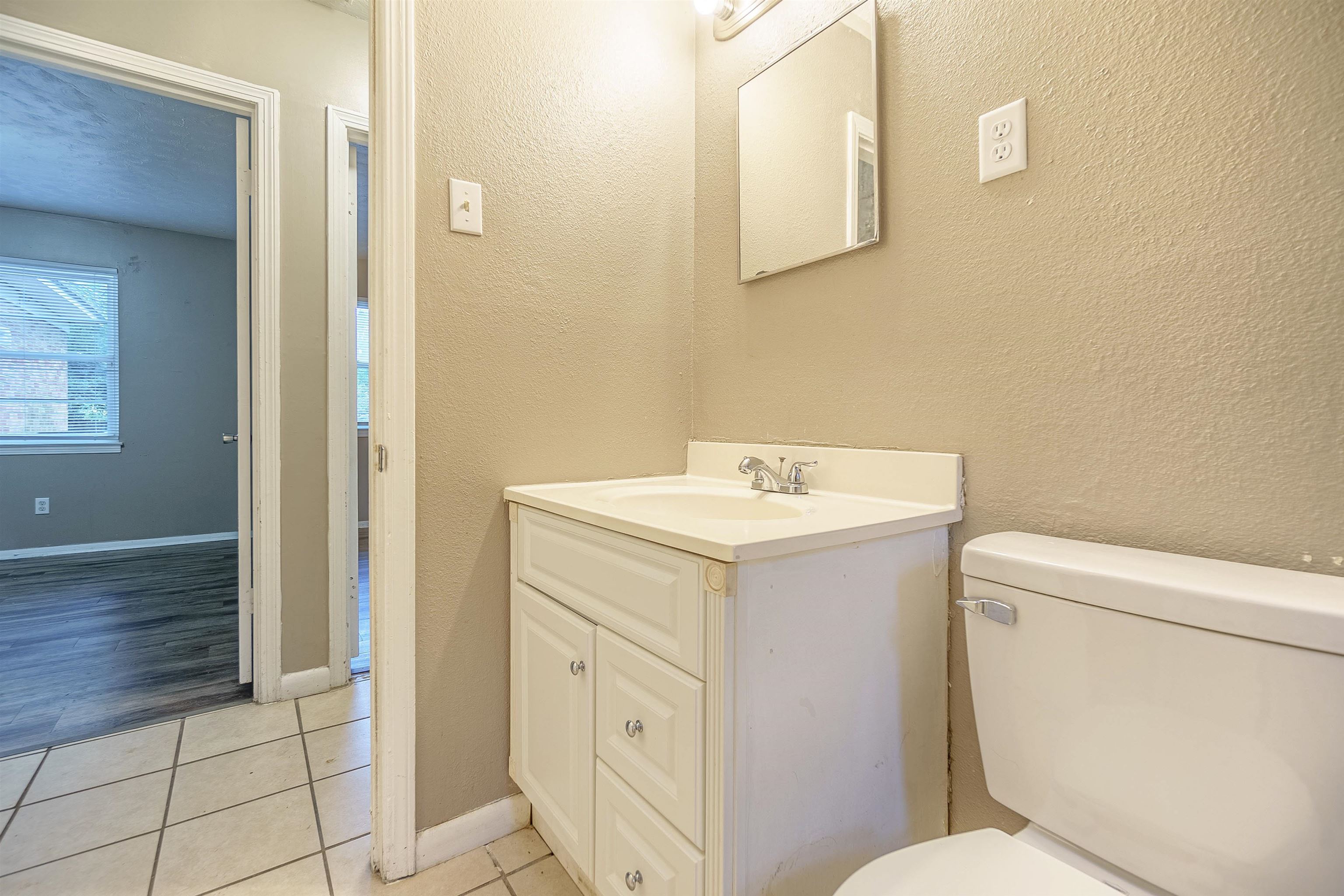 3065 Randy Lane Memphis, TN 38118 - Photo 12 of 16 a bathroom with a sink mirror vanity and toilet