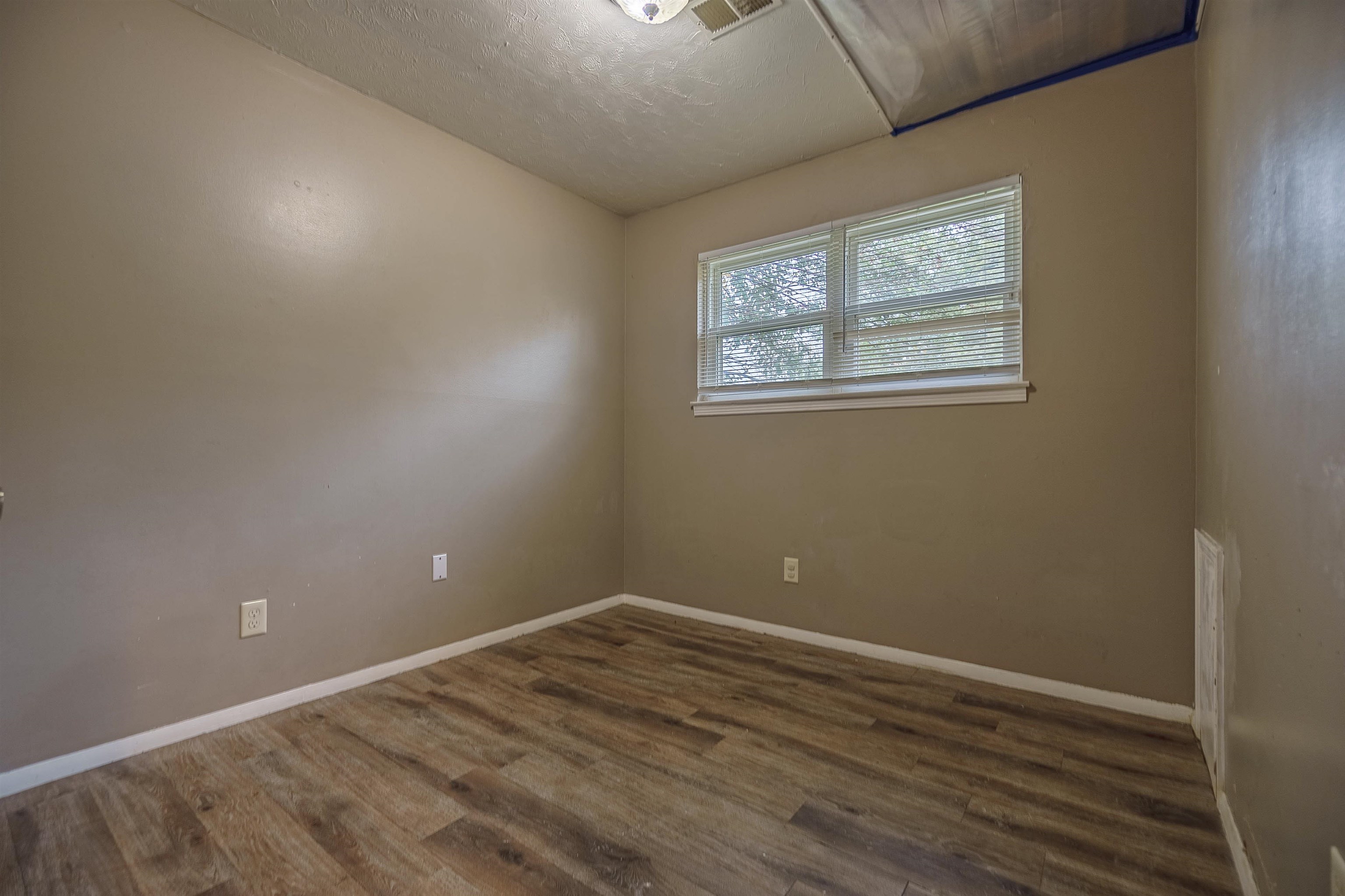3065 Randy Lane Memphis, TN 38118 - Photo 13 of 16 an empty room with wooden floor and windows