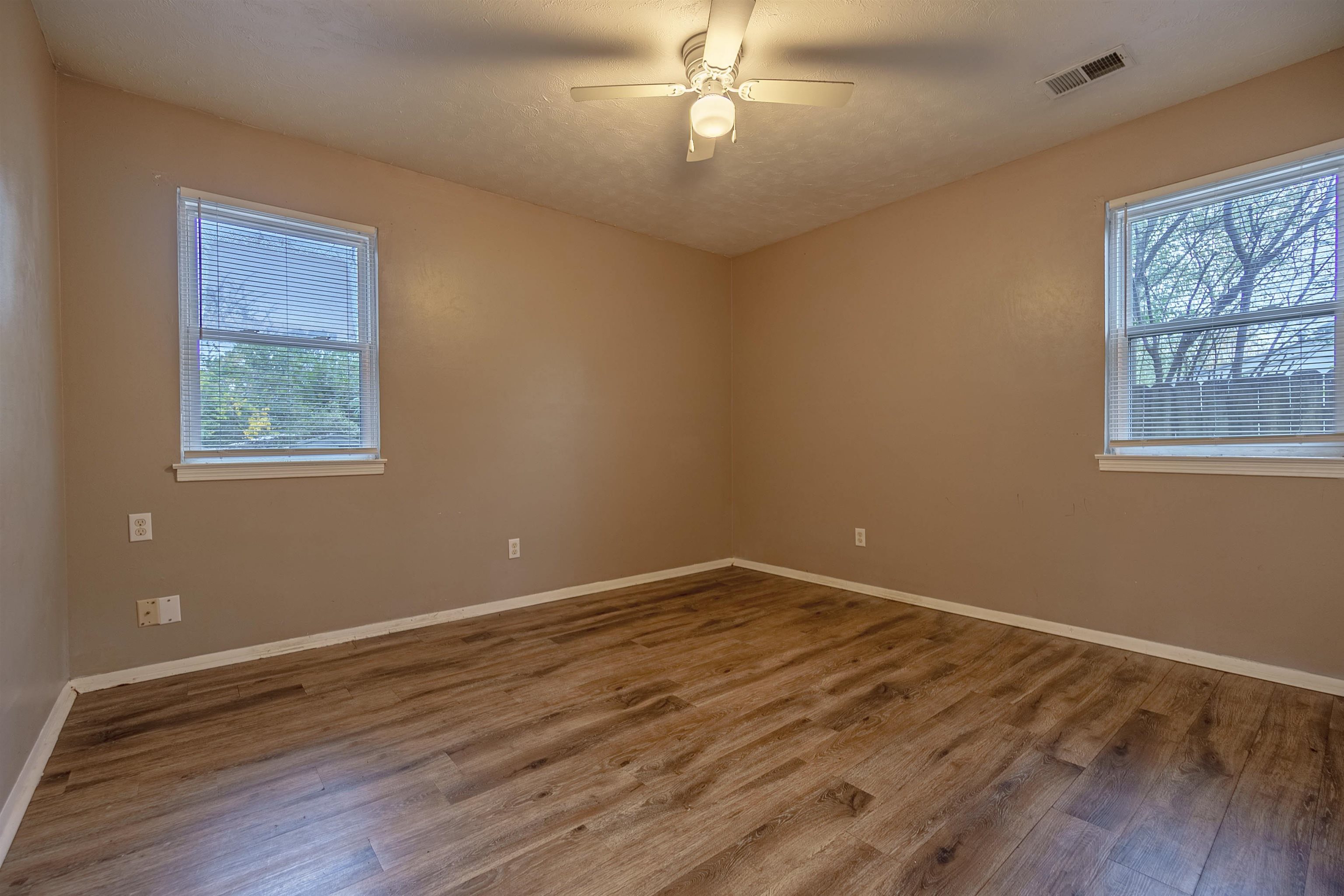 3065 Randy Lane Memphis, TN 38118 - Photo 14 of 16 a view of an empty room with wooden floor and a window