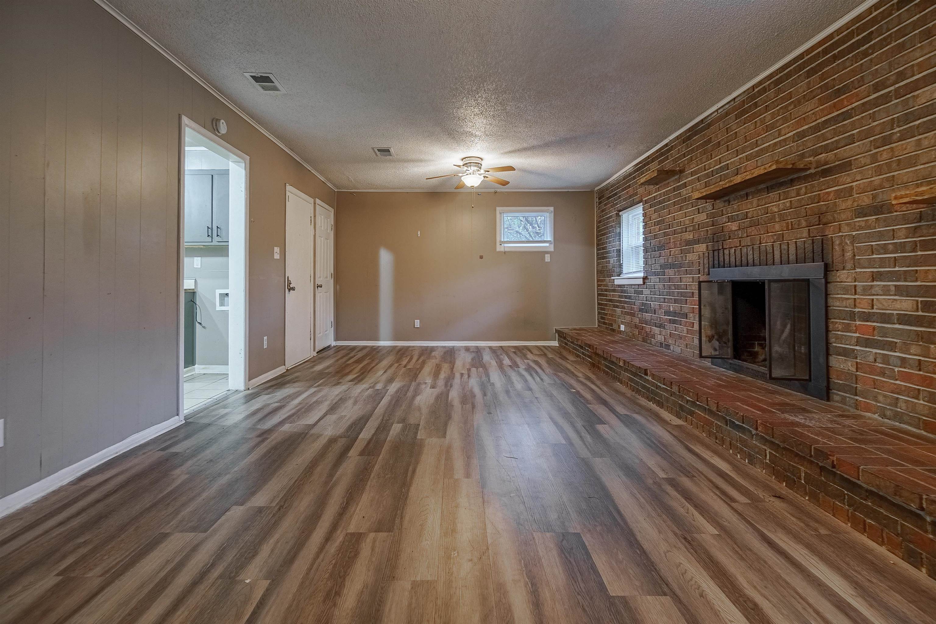 3065 Randy Lane Memphis, TN 38118 - Photo 3 of 16 a view of empty room with wooden floor and fireplace