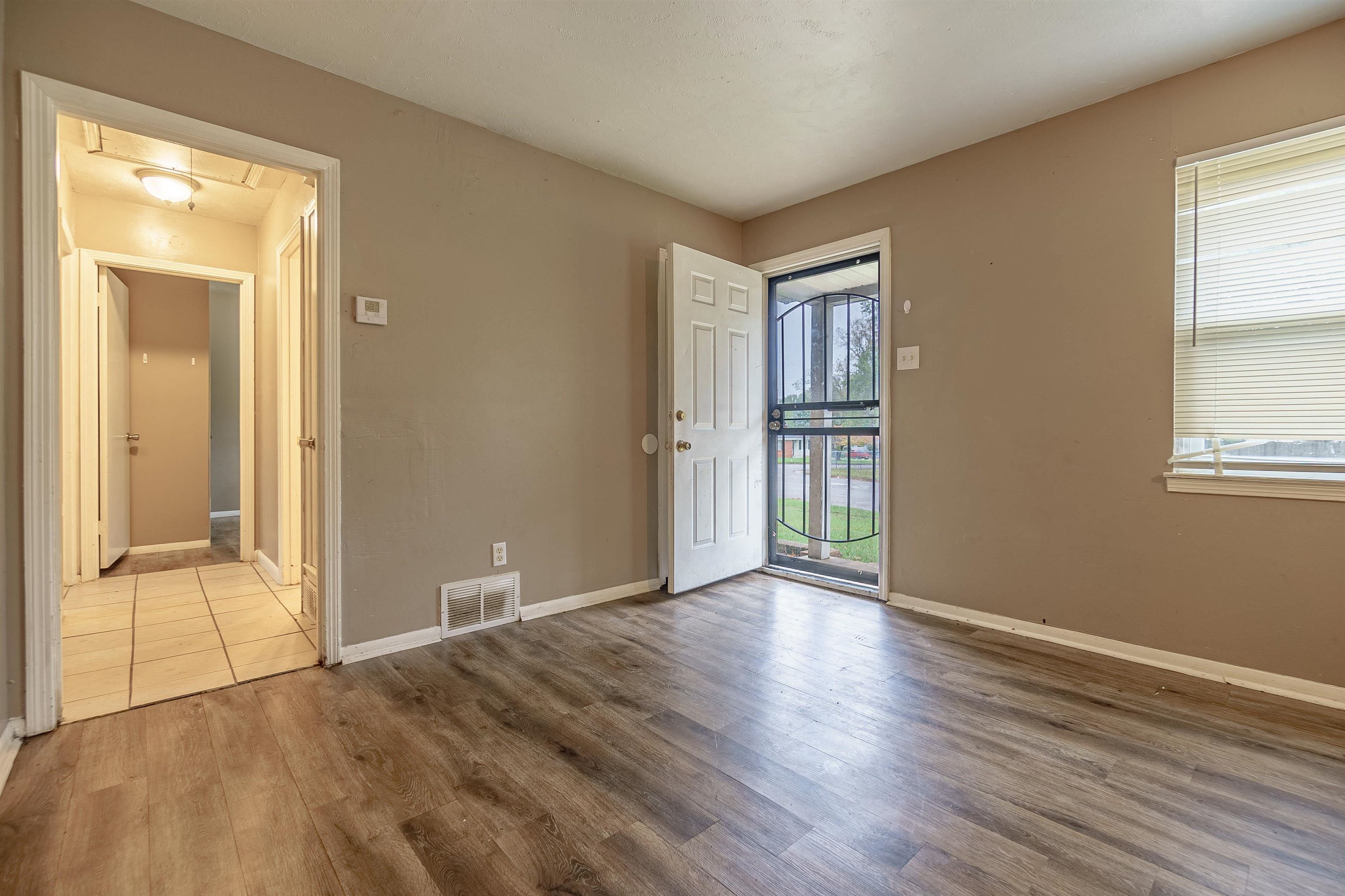3065 Randy Lane Memphis, TN 38118 - Photo 8 of 16 a view of an empty room with wooden floor and a window