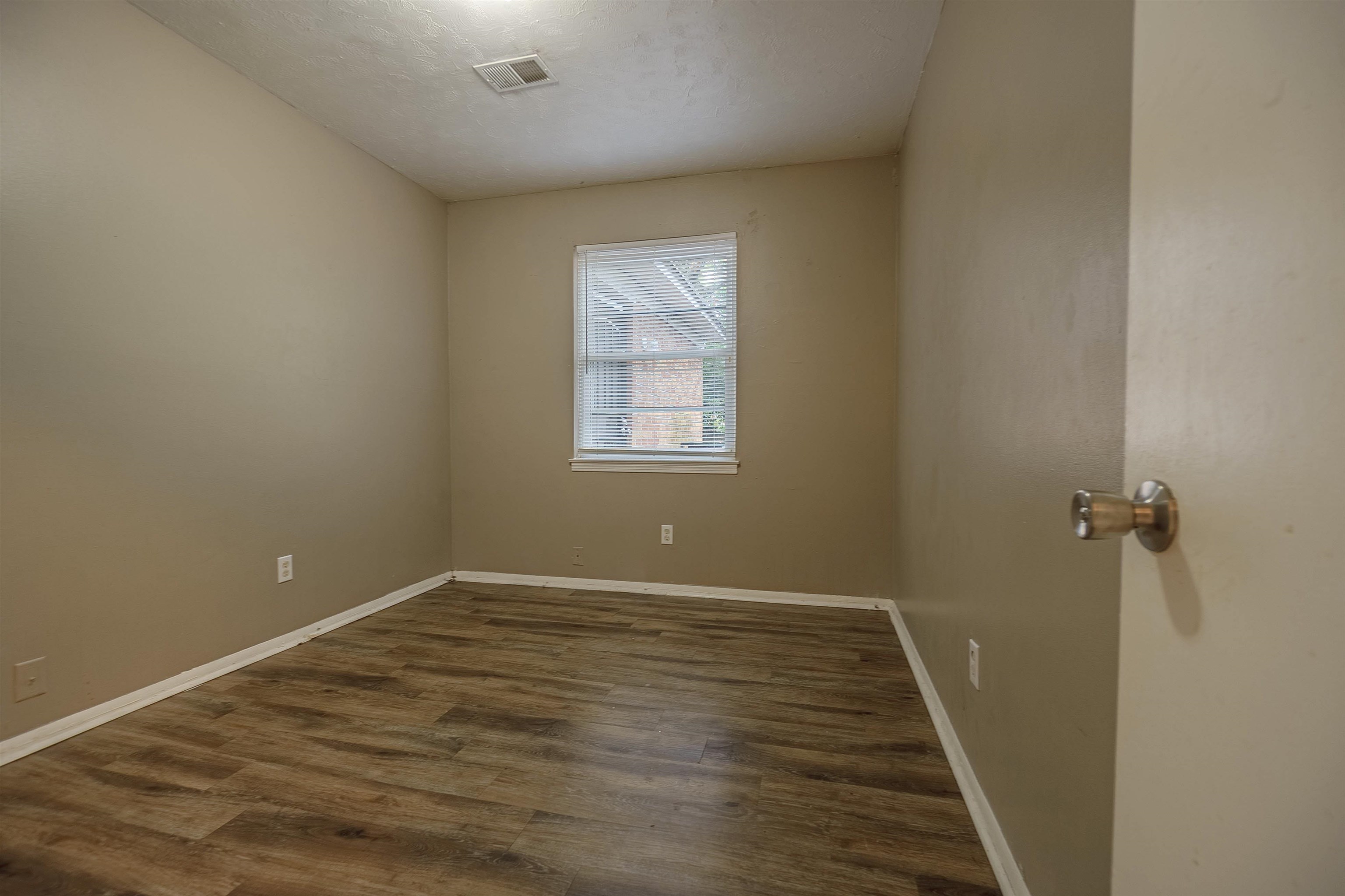 3065 Randy Lane Memphis, TN 38118 - Photo 10 of 16 wooden floor in an empty room with a window
