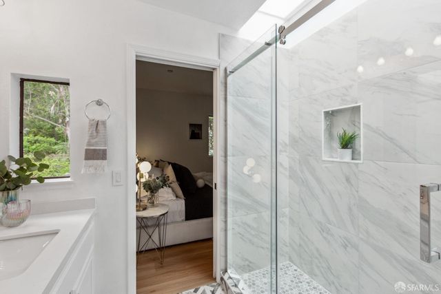 a bathroom with a sink and mirror with toilet