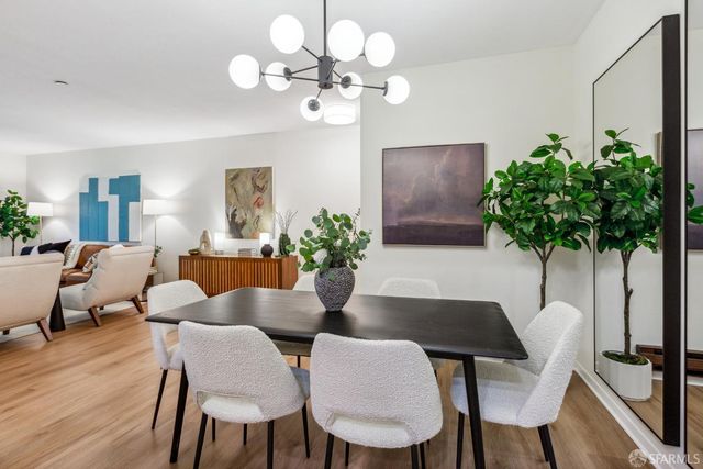 a dining room with furniture and a potted plant