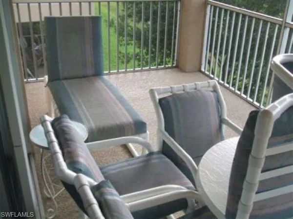 a view of a chair and table in the patio
